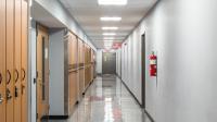 Corridor in a building, showing a fire door at the end